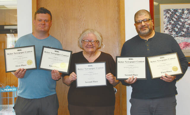 The Devils Lake Journals Joseph Mojo Hill, Louise Oleson and Mark C. Robinson display their certificates from the Better Newspaper Contest portion at the 140th annual North Dakota Newspaper Association convention in Bismarck. Hill received two first place awards for Sports Reporting Series and Sports Feature. Oleson and Robinson both received a first place award for Government Reporting on a story theyd co-written. Oleson and Robinson each received second place awards for Personal Column-Serious and Reporting Series, respectively.
                                 Photo by Micky Gleason