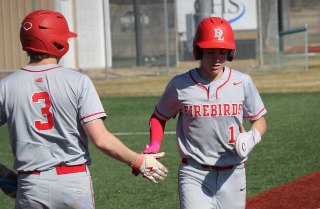 Max Palmer high-fives Will Heilman as he crosses home plate.
                                 Photo by Mojo Hill