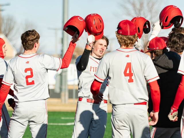Will Heilman celebrates with teammates after hitting his first high school home run.
                                 Photo by Cameron Carlson