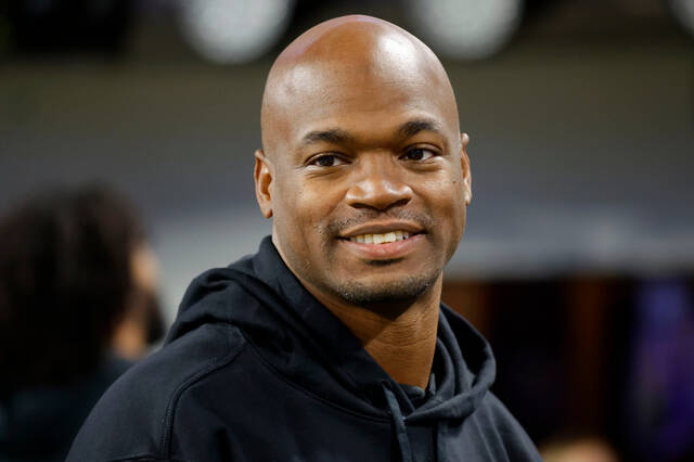 FILE - Former Minnesota Vikings running back Adrian Peterson stands on the field before an NFL football game between the Vikings and the Chicago Bears, Nov. 27, 2023, in Minneapolis.
                                 AP Photo/Bruce Kluckhohn, File