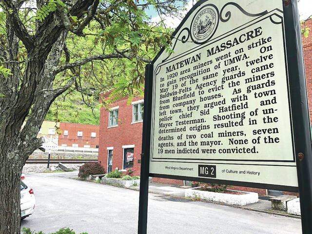 A historical sign is shown Tuesday, May 12, 2020, outside a former post office in Matewan, West Virginia. On May 19, 1920, a group of miners, who were led by a local police chief, and detectives hired by a coal company to evict unionizing miners from their homes were involved in a gun battle on the street. Ten people died in the Matewan Massacre.
                                 AP File Photo/John Raby