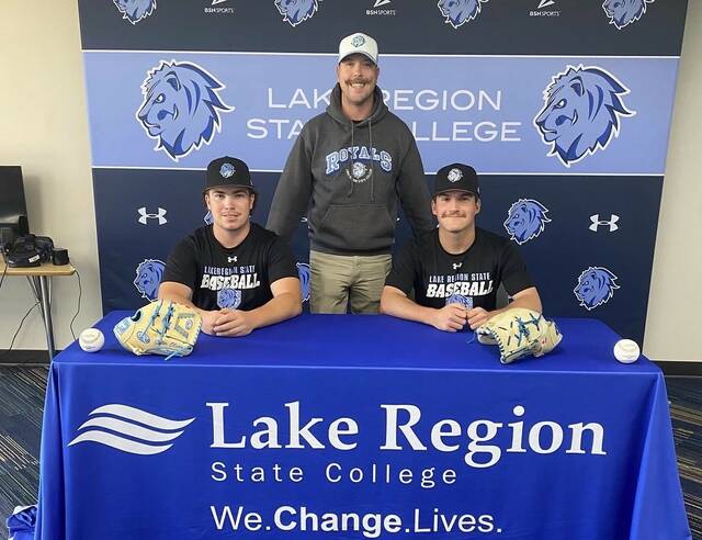 LRSC baseball players Tyler Olson (left) and Kade Maryniuk (right) pose with Royals head coach Steve Anderson as they make their signing with Mayville State official.
Photo courtesy of LRSC baseball