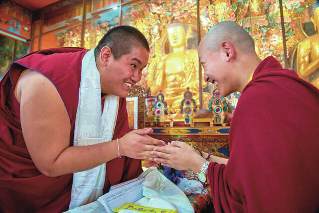 Jalue Dorje greets his friend and fellow monk, Trulshik Yangsi Rinpoche, during a ritual at Shechen Monastery in Kathmandu, Nepal, Tuesday, April 7, 2026.
                                 AP Photo/Niranjan Shrestha