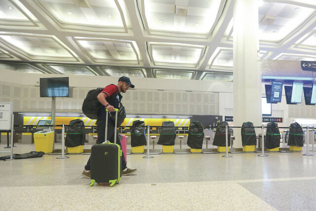 A traveler walks past covered Spirit Airlines kiosks, Saturday, May 2, 2026, at George Bush Intercontinental Airport, in Houston.
                                 AP Photo/Lekan Oyekanmi