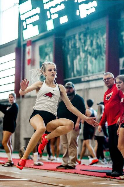 Sara Kraft jumps during an indoor track and field meet.