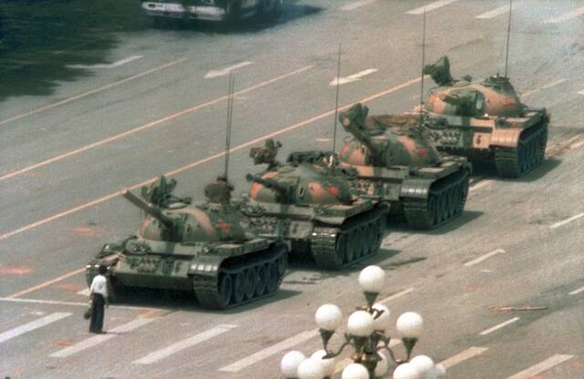 In this June 5, 1989 file photo, a Chinese man stands alone to block a line of tanks heading east on Beijings Changan Blvd. in Tiananmen Square, during the student-uprising and the violent crackdown on pro-democracy protests that began in Beijings Tiananmen Square on June 4, 1989.
                                 AP Photo/Jeff Widener, File