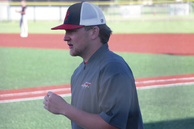 Jackson Baeth turns to talk to head coach Parker Schmid outside the dugout between innings.
                                 Photo by Mojo Hill