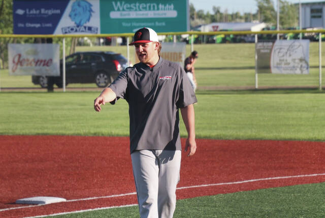 Jackson Baeth gestures to one of his players on the first base sideline.
                                 Photo by Mojo Hill