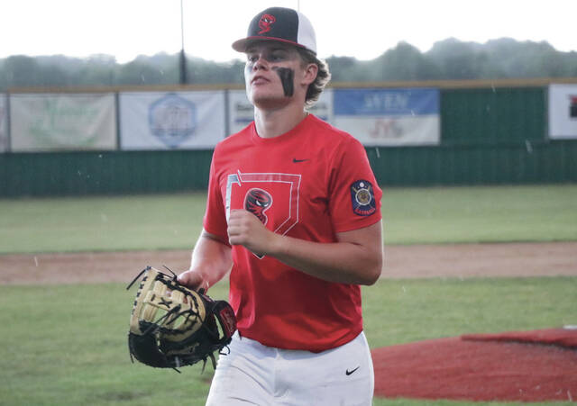Hunter Remmick jogs back into the dugout from the field.