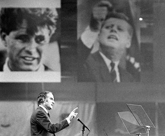 Portraits of assassinated brothers Robert F. Kennedy and John F. Kennedy provide a backdrop as Sen. George McGovern accepts the Democratic presidential nomination at the closing session of the Democratic National Convention in Miami Beach, Fla., in this July 14, 1972 file photo.
                                 AP Photo/Ray Stubblebine, File