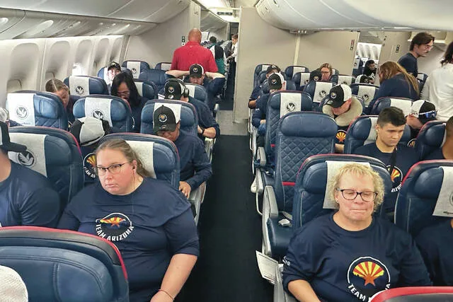 Members of teams from Arizona and New Mexico sit in their seats after boarding their flight to the 2026 Special Olympics USA Games Friday, June 19, 2026.
                                 AP Photo/John Marshall
