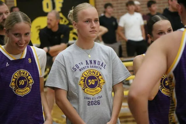 Devils Lakes Presley Brown (center) stands during the pregame lineup announcements.
                                 Photo by Mojo Hill