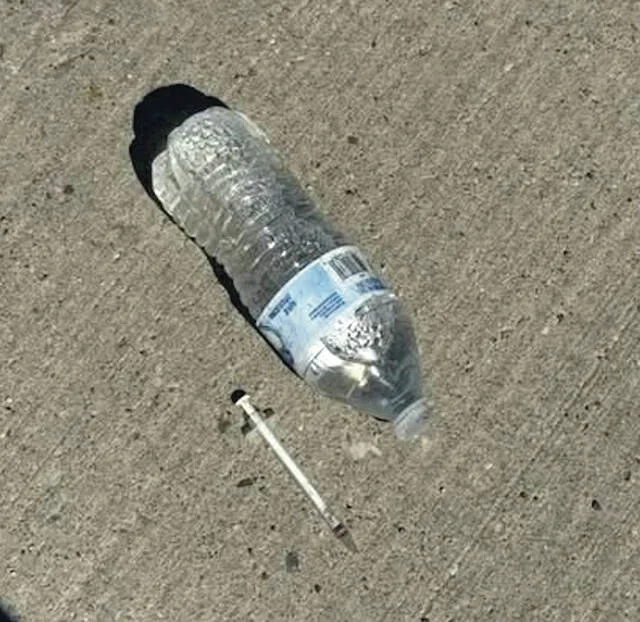Photos posted on Facebook by Devils Lake City Commissioner Jason Pierce of alleged drug paraphernalia, including a hypodermic needle and a small measuring spoon several feet away, found in the parking lot south of the 20/20 Eye Care clinic on 211 4th St NE.
                                 Photos courtesy of Jason Pierce