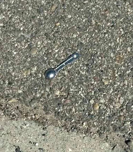 Photos posted on Facebook by Devils Lake City Commissioner Jason Pierce of alleged drug paraphernalia, including a hypodermic needle and a small measuring spoon several feet away, found in the parking lot south of the 20/20 Eye Care clinic on 211 4th St NE.
                                 Photos courtesy of Jason Pierce