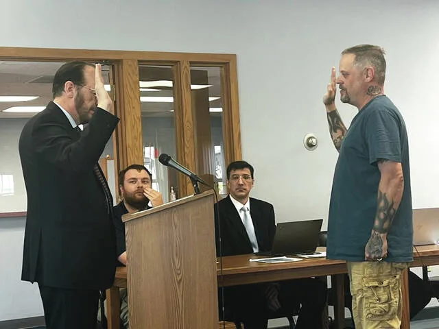 Judge Peter Halbach administers oath of office to Commissioner Jason Pierce for another term at the July 6 meeting of the Devils Lake City Commission.
                                 Photo by Mark C. Robinson