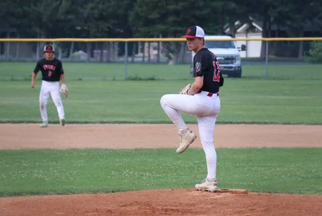 Riley Brenno-Quale steps into his windup while pitching for the Storm B team in the first round of the District 3 baseball tournament in Bottineau.
                                 Photo by Mojo Hill
