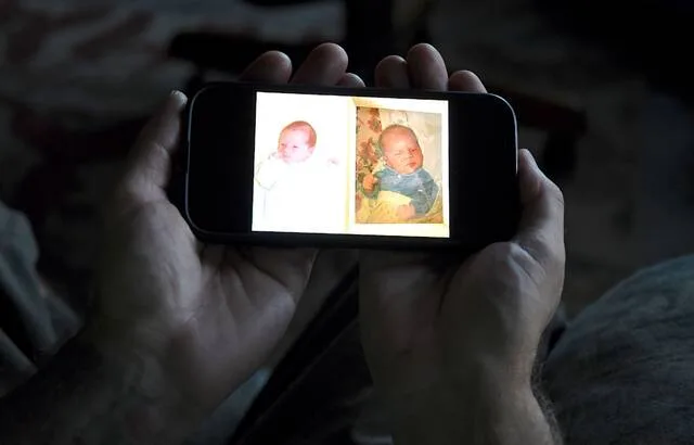 Jeremy Morrison, who says he was sent home with the wrong parents after he was born, shows what he believes is a baby photo of him, left, and of the other baby he says was switched at birth while recounting the story at his home in Colorado City, Colo., on Thursday, July 16, 2026.
                                 AP Photo/Thomas Peipert