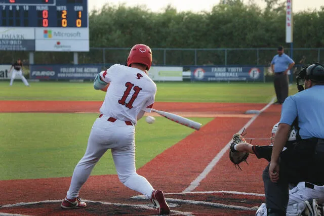 Fausten Olson times up a ball at the plate.