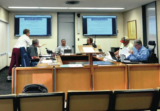 HR consultant Nicole Bakkegard provided material to review proposed changes to the county employee salary schedule for County Commissioners at special meeting held the morning of Monday, July 27 in the Commission Meeting Room at the Ramsey County Courthouse.
                                 Photo by Mark C. Robinson