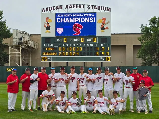 The 2026 Devils Lake Storm Legion A team poses in front of the scoreboard at Ardean Aafedt Stadium after winning the state championship game over Fargo Post 2.
                                 Photo courtesy of Tana Triepke