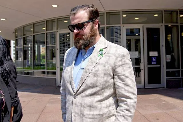 Colin Hortman, son of Melissa and Mark Hortman, leaves after attending the initial state court appearance for Vance Boelter, Monday, Aug. 3, 2026, in Minneapolis.
                                 AP Photo/Ellen Schmidt