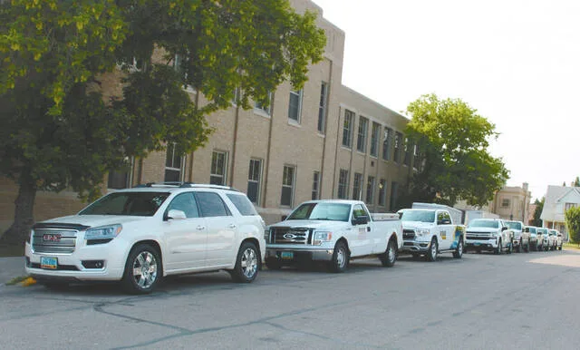 Meanwhile several vehicles were parked along the west side of the middle school, most bearing signs from various electrical companies servicing the renovations.