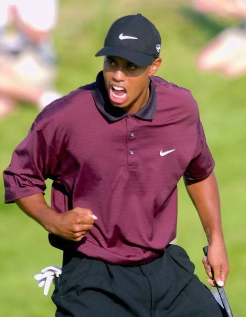 Tiger Woods celebrates making birdie on the last of regulation play to tie Bob May at 18-under-par and force a playoff at the PGA Championship, Sunday, Aug. 20, 2000, at the Valhalla Golf Club, in Louisville, Ky.
AP File Photo/Rob Carr
