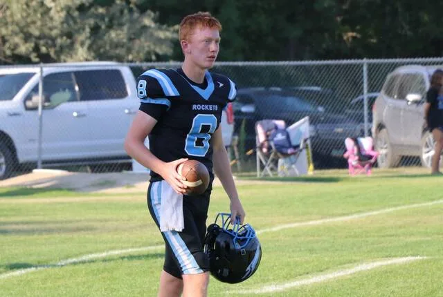 Jax Demester takes a breather with his helmet off during warmups before his first game as a starting quarterback at New Rockford Athletic Field.
                                 Photo by Mojo Hill