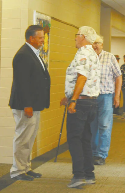 Here Superintendent Ned Clooten (left) visits with Arne Berg in the hallway of the north wing of Prairie View Elementary School during the event that allowed the public access to the newly renovated facility on Aug. 19, 2026.