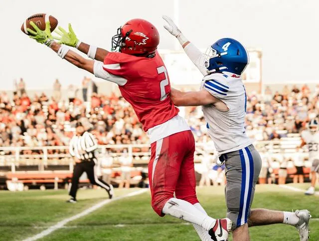 Devils Lakes Domingo Engberg reaches up for a catch while fending off a Kindred defender during the Firebirds 2026 season opener at Roller Field on Friday, Aug. 28.