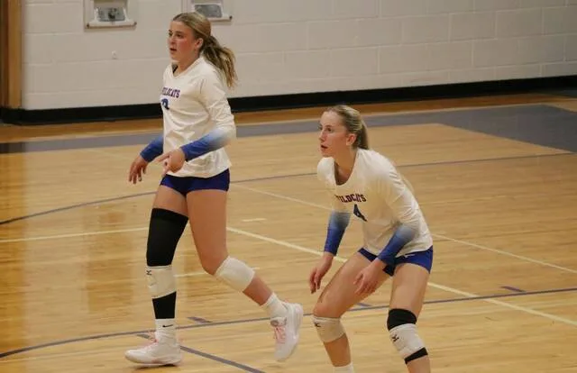 Liberty Streyle (left) runs up the court while Addisyn Faul (right) gets set to try to receive the ball during Benson County volleyballs match against TGU in Leeds on Thursday, Sept. 3.