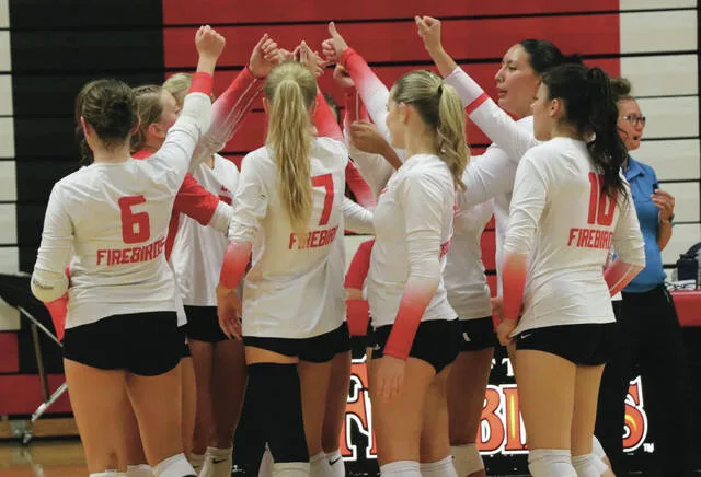 The Devils Lake volleyball players extend their arms into the huddle in between points during the Firebirds 2026 season opener against Bottineau at the Devils Lake Sports Center on Tuesday, Sept. 1.
                                 Photo by Mojo Hill
