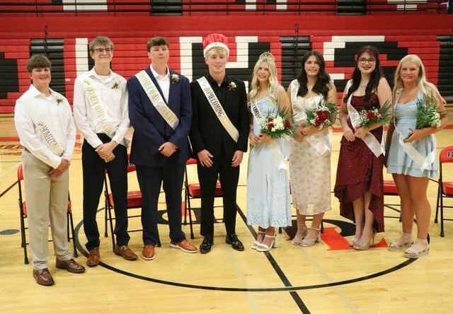The entire homecoming court gathers for a picture in the Devils Lake Sports Center gym.