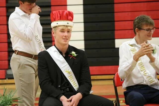 Easton Encinas grins after receiving the homecoming king crown.