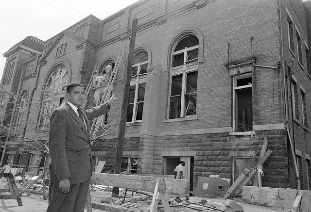 Rev. John Cross points to the wreckage of the 16th Street Baptist Church in Birmingham, Ala., Sept. 19, 1963. The church was damaged heavily by a bomb blast on Sunday, Sept. 15, which killed four young girls and injured many others.
AP Photo