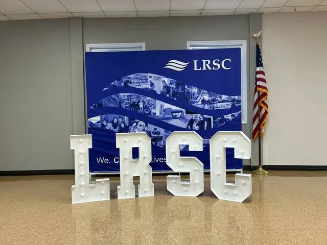 Many of those in attendance posed for pictures with this LRSC display in the dining room.
                                 Photo by Mojo Hill