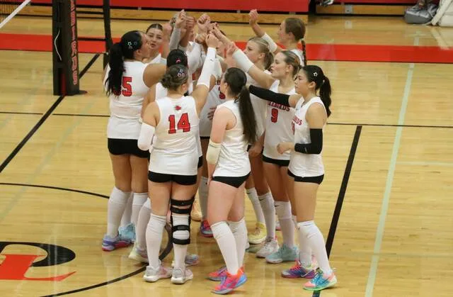 The Devils Lake volleyball team breaks from a huddle during a match at the Devils Lake Sports Center.
Photo by Mojo Hill