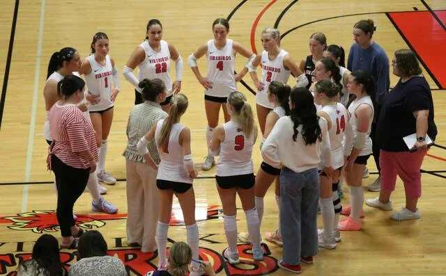 The Devils Lake volleyball team listens to head coach Tangella Martinson during a timeout during the Firebirds match against Carrington on Tuesday, Sept. 22 at the Devils Lake Sports Center.
Photo by Mojo Hill