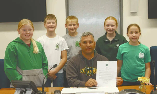 From left to right, Ezri D., Thomas S., Landan L., Ramsey County Commission Chairman Blaine Volk, Sadee N. and Lydia V.